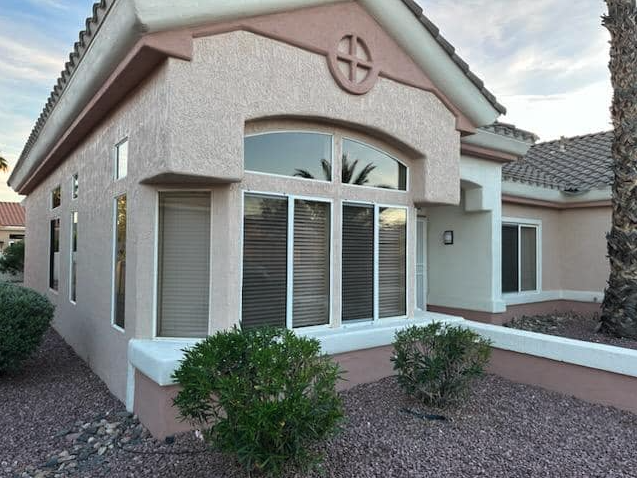 Arched picture window cleaned on a tile-roof Phoenix home